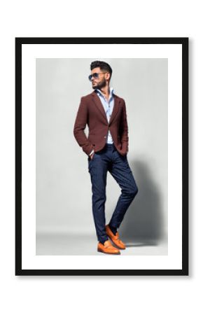 Elegant young handsome man in suite wearing glasses. Studio fashion portrait.