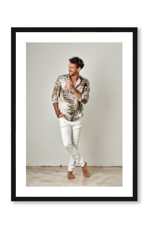 Handsome man in summer shirt and white pants laughing