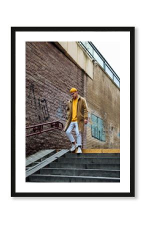 Photo of a young fashion stylish trendy look man model  in color clothes modern style outdoor street style  natural light