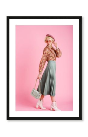 Full-length studio fashion portrait of young elegant happy smiling woman wearing trendy spring outfit: floral print blouse, green pleated skirt, white ankle boots, holding stylish  faux leather bag