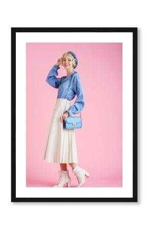 Full-length studio fashion portrait of young elegant happy smiling woman wearing trendy spring outfit: blue blouse, white pleated skirt, ankle boots, with stylish small faux leather shoulder bag