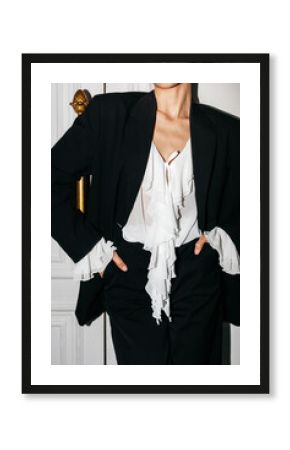 Anonymous female showcases fashion black suit outfit