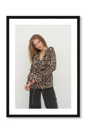 Stylish model showcases chic animal print fashion in a bright studio setting