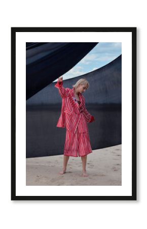girl model in red striped jackets against the sky in the desert, fashion shoot in the desert.