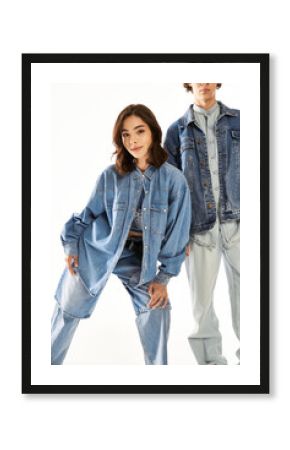 Stylish young couple expressing love through modern denim fashion in bright studio setting
