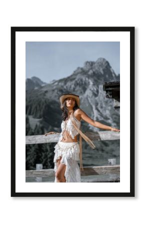 Summery fashion shoot in the mountains with two young women in modern cowgirl and trend-inspired outfits. Confident looks and natural scenery – perfect for lifestyle and fashion branding.