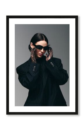 Stylish young woman poses dramatically in modern fashion setting