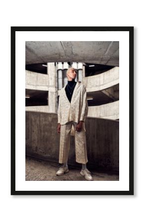 male fashion model posing in a concrete city carpark 