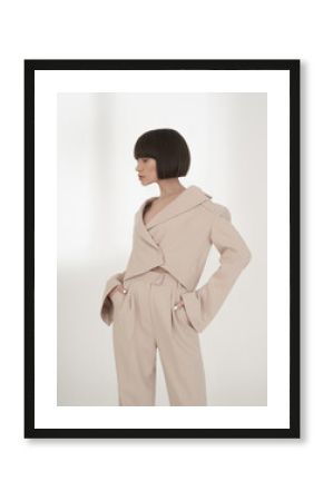 Beautiful brunette with graphic bob haircut wear beige fashion pantsuit