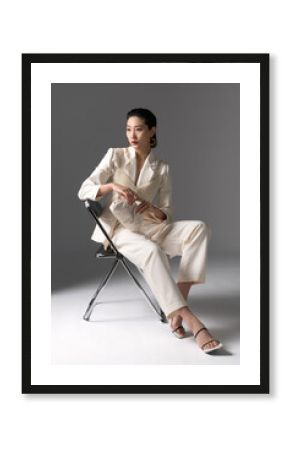 Fashionable young woman posing on chair