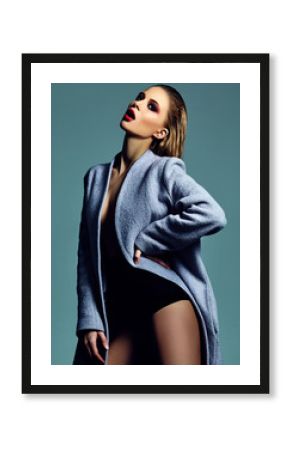 High fashion look.glamor beautiful sexy hot stylish young blond woman model with bright makeup in overcoat in studio