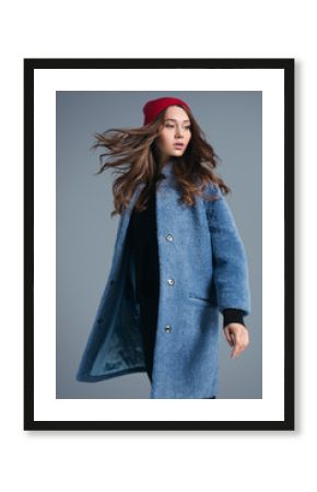 Girl in blue fur coat and red hat