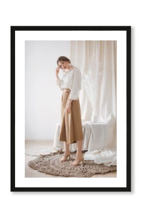 Portrait of beautiful young woman with makeup in fashion white clothes