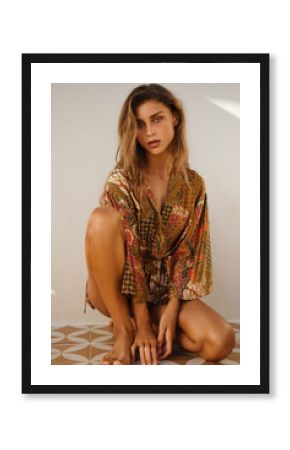 Natural light portrait of a woman in a see-through lace mini dress looking down thoughtfully. A blend of intimacy and fashion captured in golden hour tones.