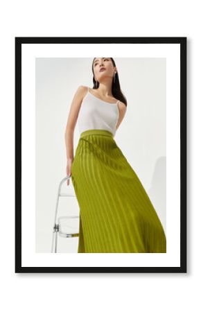 Elegant fashion pose wearing a green skirt.