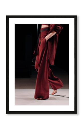 Fashion details of trendy red burgundy sweater, pants and crop top, women's fashion cloth concept on black background