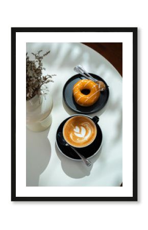 Hot coffee latte with latte art milk foam in cup mug and Homemade Orange Donut wood desk on wood desk on top view. As breakfast In a coffee shop at the cafe,during business work concept