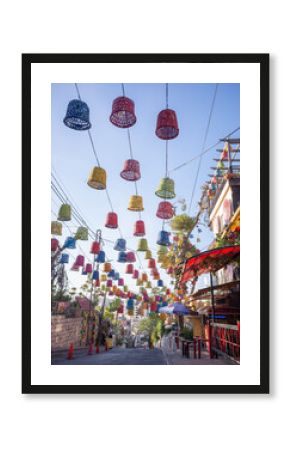 colorful ornaments hanged in the air in front of the cafe of rainbow street in capital amman