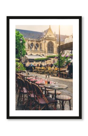Cozy street with tables of cafe in Paris, France