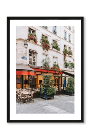 Typical view of the Parisian street with tables of brasserie (cafe) in Paris, France