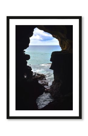 View of the Atlantic ocean through a large hole inside the caves of Hercules, Morocco