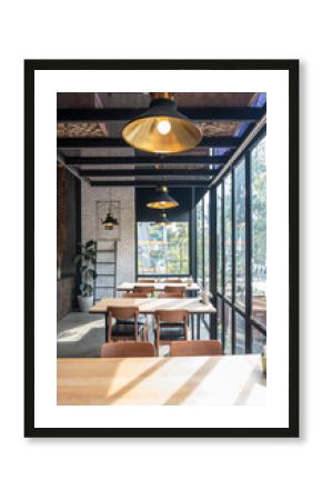 Table and chair set in modern cafe minimalistic interior design with big window and hanging ceiling lamps