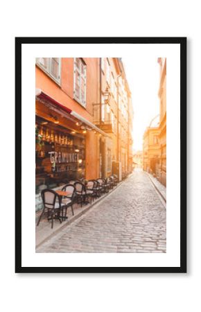  Narrow street with cafe in with beautiful sky.