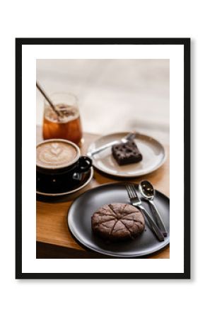 Set of Dessert food and drink Latte coffee, Iced coffee, chocolate brownie cookies and cake on the wooden cafe table.