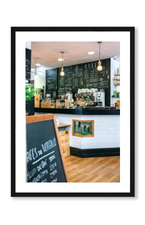 Empty cafe interior with coffee maker and blackboard with menu