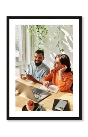 Creative collaboration of a modern couple working remotely in a vibrant cafe space