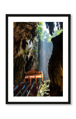 Visitors climbing colorful steps inside Batu Caves, Kuala Lumpur