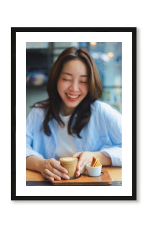 Close up Asian woman hands holding a cup of hot coffee at modern cafe, representing freelance lifestyle, digital nomad, and online business success