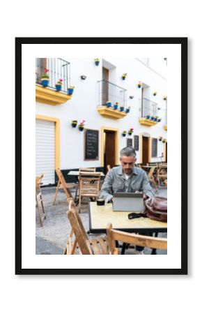 Freelance working remotely at outdoor cafe