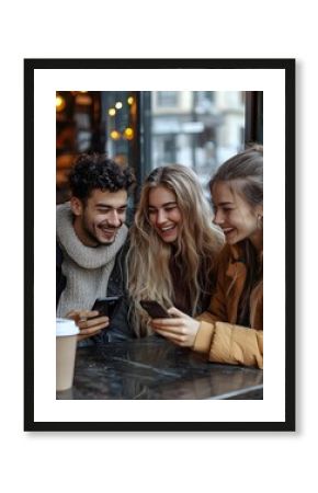 Group of friends laughing and looking at cellphone photos together