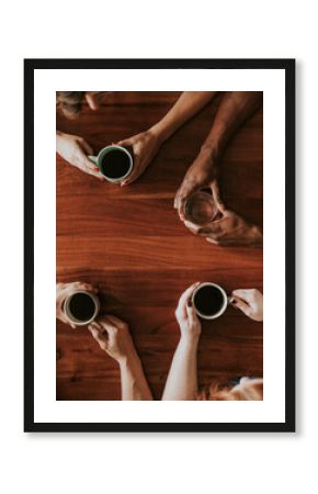 Friends having coffee and talking at a cafe