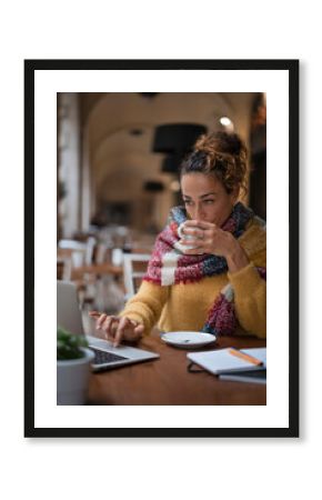 Woman working with a laptop in a cafe