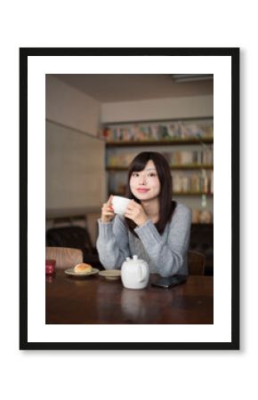 カフェでお茶を飲んでいる女性
