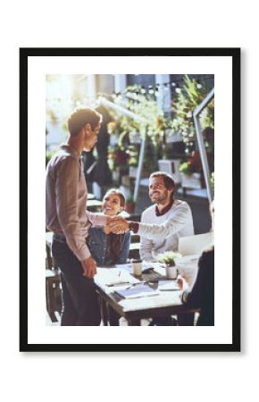 Business people, team and shaking hands in meeting at cafe for welcome, b2b networking or collaboration outdoor. Group, employees and handshake for onboarding, partnership deal or happy for agreement