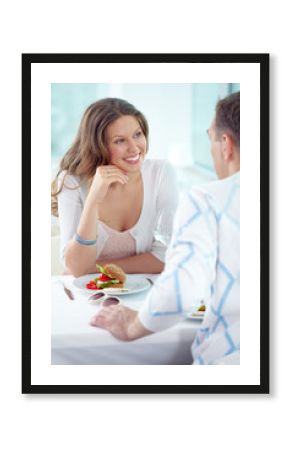 Affectionate couple dining in cafe and communicating