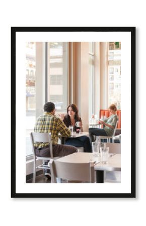People friends sitting at table having coffee together in cafe restaurant