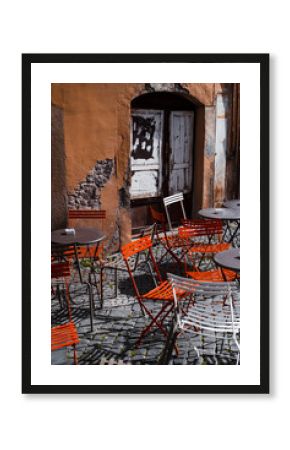atmospheric street cafe - empty tables against grungy wall in Firenze, Italy
