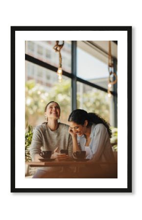 Female friends smiling in a cafe