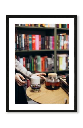 Tea and a chessboard on a table in a bookstore cafe.