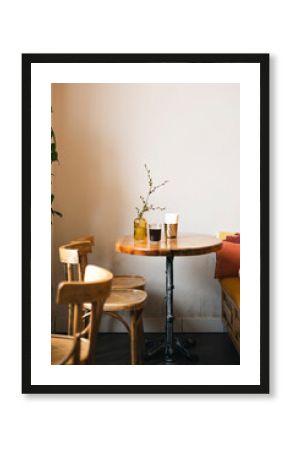 Cozy wooden cafe corner with vase and drinks on table