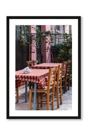 Outdoor cafe tables with checkered tablecloths in Plaka
