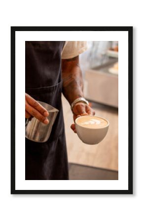 Barista preparing latte art in coffee shop