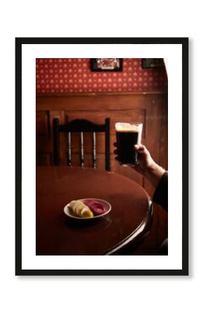 pint of stout. Craft beer in pub on wooden table. Glass of beer