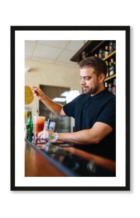 Bearded man working in pub in daytime