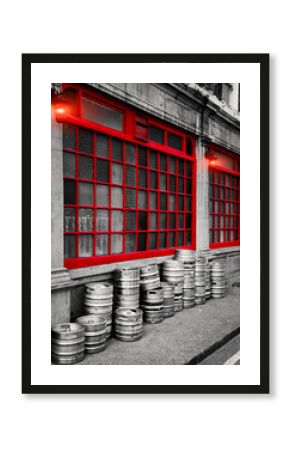 Dublin Street, Row of stacked beer kegs outside of a building.  The image shows a part of a traditional pub in Dublin showcasing its classic architectural design.