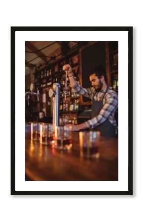 Waiter using beer tap at counter